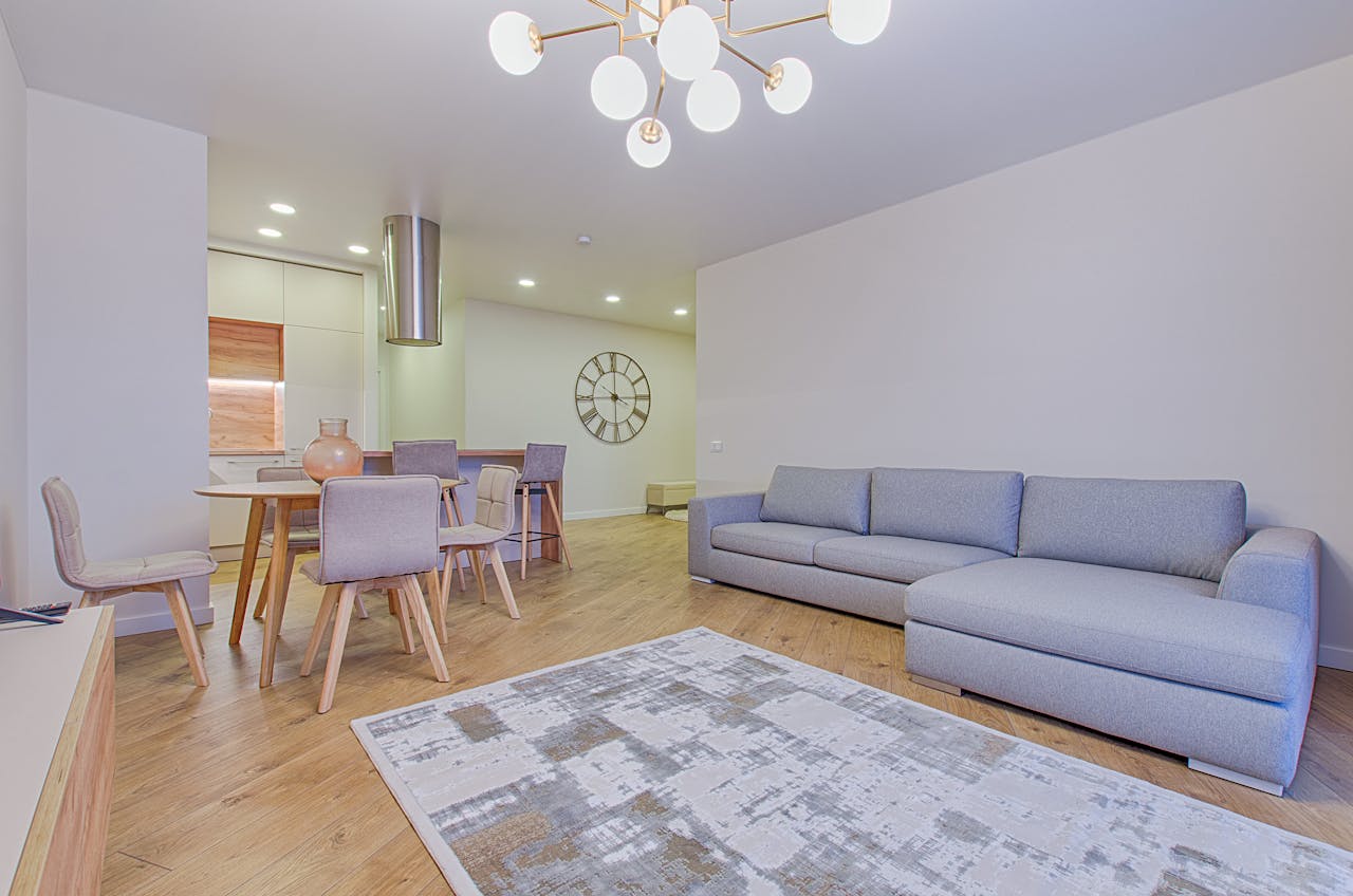 Spacious contemporary living room featuring stylish furniture and elegant lighting.